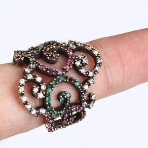 Ruby, emerald & white topaz scroll ring